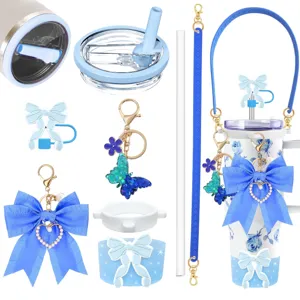 Blue floral tumbler set with cute bow charms, straw lid, and matching accessories.