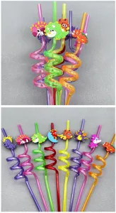Detailed view of colorful plastic spiral drinking straws featuring cute cartoon dinosaur charms for kids.