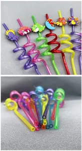Colorful plastic spiral drinking straws with cute cartoon dinosaur toppers for kids party.
