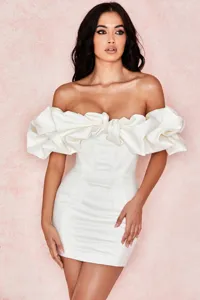 White off-shoulder corset mini dress featuring dramatic ruffle sleeves and boned bodice.