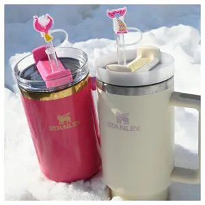 Stanley tumbler detail showing hot pink and cream cups with cute mermaid tail straw toppers.