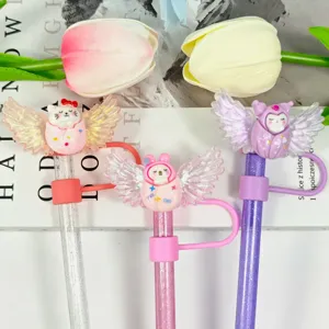 Close-up detail of cute cartoon angel wings straw dust covers, sparkling glitter design.