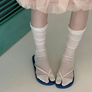 Close-up of comfortable split-toe socks paired with sandals, casual daily wear style.