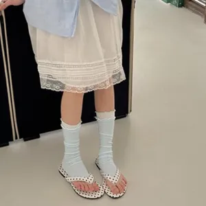 Women ruffle mid-calf socks detail shot showing breathable cotton fabric and delicate lace trim design.