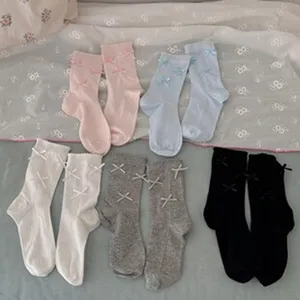 Cotton mid-tube socks with cute bow details, comfortable breathable everyday wear. Detail view.