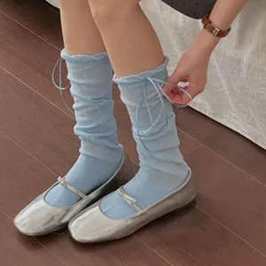 Light blue slouchy socks detail view, breathable knitted fabric with adjustable drawstring.