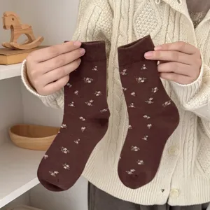 Detailed close-up shot of brown floral mid-tube socks, vintage style cozy winter warm knit socks.