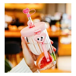 Cute pink glass tumbler with heart straw cover and cartoon charm, perfect for daily use.