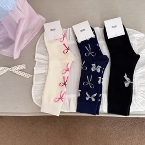 Detail view of women cotton crew socks with bow print, breathable and soft fabric detail.