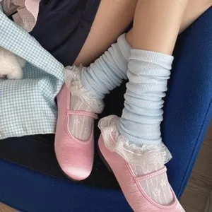 Detail shot of sweet blue ribbed socks and white lace ruffle socks paired with pink shoes.