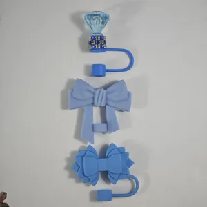 Blue silicone straw covers with cute bow and diamond designs for tumbler cups, dust-proof accessories.
