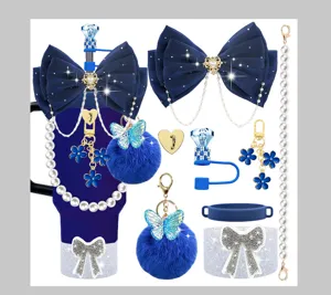 Detailed view of blue tumbler accessories set including bow charms, pearl chains and pom poms.