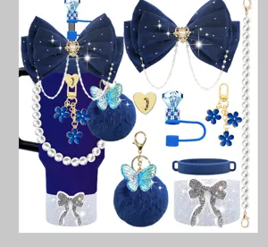 Stanley cup accessories set featuring dark blue bows pearl chains and fluffy pom pom keychains.