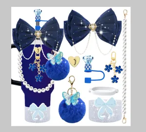 Stanley cup accessories set with blue bows, pearl chains, and cute pom-pom keychains.