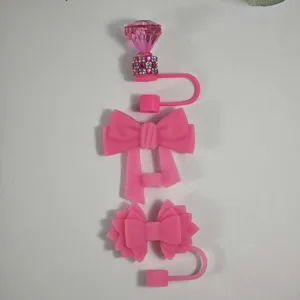 Pink silicone straw covers and cute bow dust plugs, perfect tumbler cup accessories.