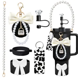 Set of tumbler accessories including pearl chain, bow keychain, straw cover and pouch.