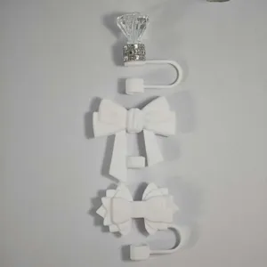 Silicone straw cover set featuring cute bow and diamond designs for Stanley cup accessories.