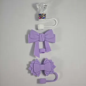 Silicone straw covers detail shot, decorative bow and diamond tumbler accessories.