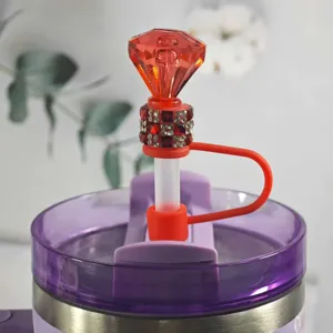 Detailed close-up of a vibrant red diamond-shaped silicone straw cover with dazzling rhinestones.