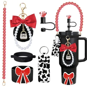 Tumbler accessory set featuring pearl strap, bow keychain, and cow print lipstick holder
