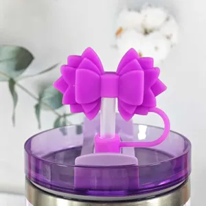 Detail view of purple silicone bow straw topper for tumbler cups, cute dust proof cover.
