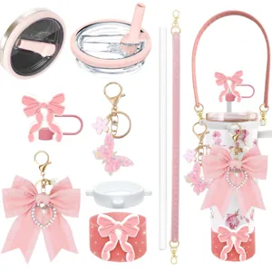 Pink tumbler accessory set with cute bows, butterfly keychains, strap and straw lids for cup.