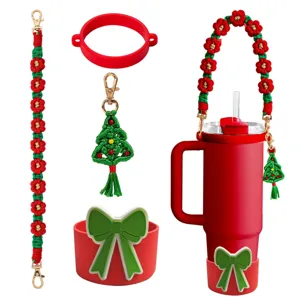 Christmas Stanley tumbler accessory set with braided strap, silicone bow boot and tree charm.