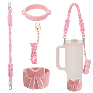 Handmade woven water bottle strap set with cute pink bow silicone boot and lipstick pouch detail.