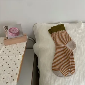 Cozy autumn winter striped mid-tube socks with olive green cuffs for women, soft daily casual.