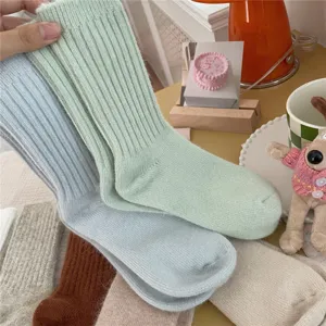 Cozy thick ribbed knit winter socks for women, soft solid color warm mid-tube socks.