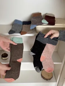 Merino wool colorblock thermal mid-tube socks for winter warmth and cozy daily wear.