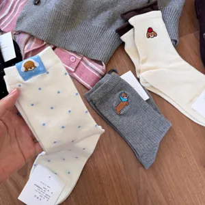 Cute cartoon dachshund embroidered women mid-tube socks, soft combed cotton cozy daily wear.