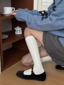 Detail shot of Japanese minimalist knit calf socks for women, cozy winter hosiery pairing.