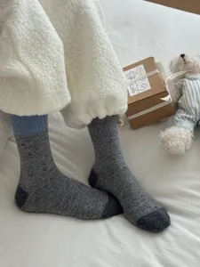 Close-up detail of winter warm merino wool colorblock mid-tube socks, soft and cozy fit.