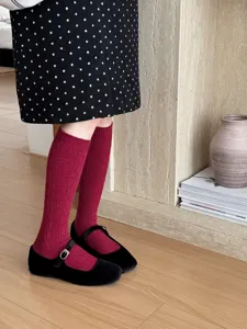 Japanese style thick solid color calf socks detail view, paired with black retro Mary Jane shoes.