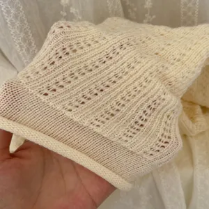 Close up view of the cozy knitted leg warmer fabric texture, showing the soft and warm material details.