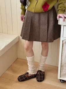 Cozy beige knit leg warmers with delicate lace trim, perfect for cozy winter styles.