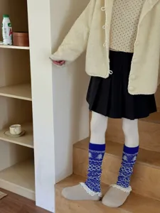 Detail view of autumn winter thick warm Fair Isle knitted footed leg warmers socks for women.