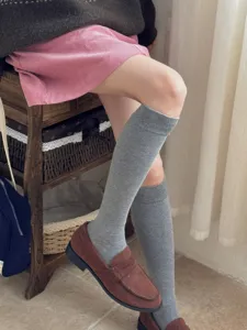 Cozy gray knee-high socks for women, solid color long fashion knit stockings for daily wear.