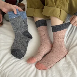Thickened Merino wool color-block mid-tube socks for winter warmth and cozy daily wear.