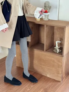 Detailed view of gray knit tights, showing soft and comfortable fabric for daily autumn outfits.