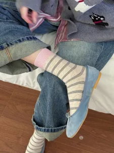 Detailed shot of Japanese-style striped mid-tube socks, showcasing cozy daily wear texture.