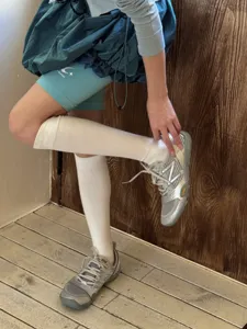 Solid color sports knee-high socks detail view, comfortable anti-slip athletic calf socks for daily wear.