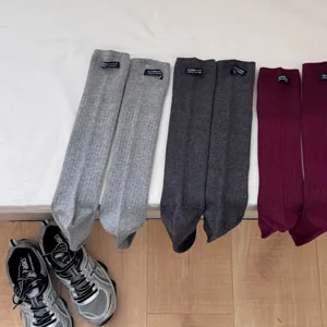 Casual solid color long socks for women, spring autumn aesthetic calf socks with cute small tag.