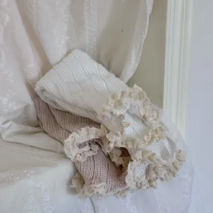 Knit leg warmers detail featuring soft chunky knit fabric and delicate lace ruffle trim.