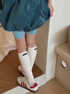 White ribbed calf socks for women, soft cotton casual crew socks with small label.
