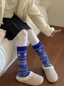 Detailed shot of cozy thick knit Fair Isle slouch leg warmers in blue and white pattern.