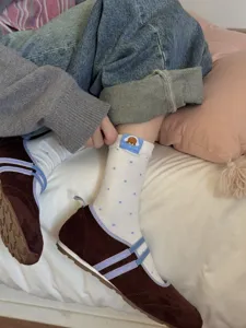 Cute cartoon dachshund embroidered white mid-calf socks with blue polka dots for autumn winter.