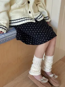 Detailed shot of cozy knit leg warmers featuring cable knit texture, warm and stylish wear.