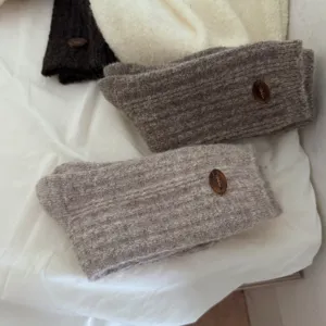 Detailed view of cozy knit wool socks with decorative button, warm winter casual cashmere socks.